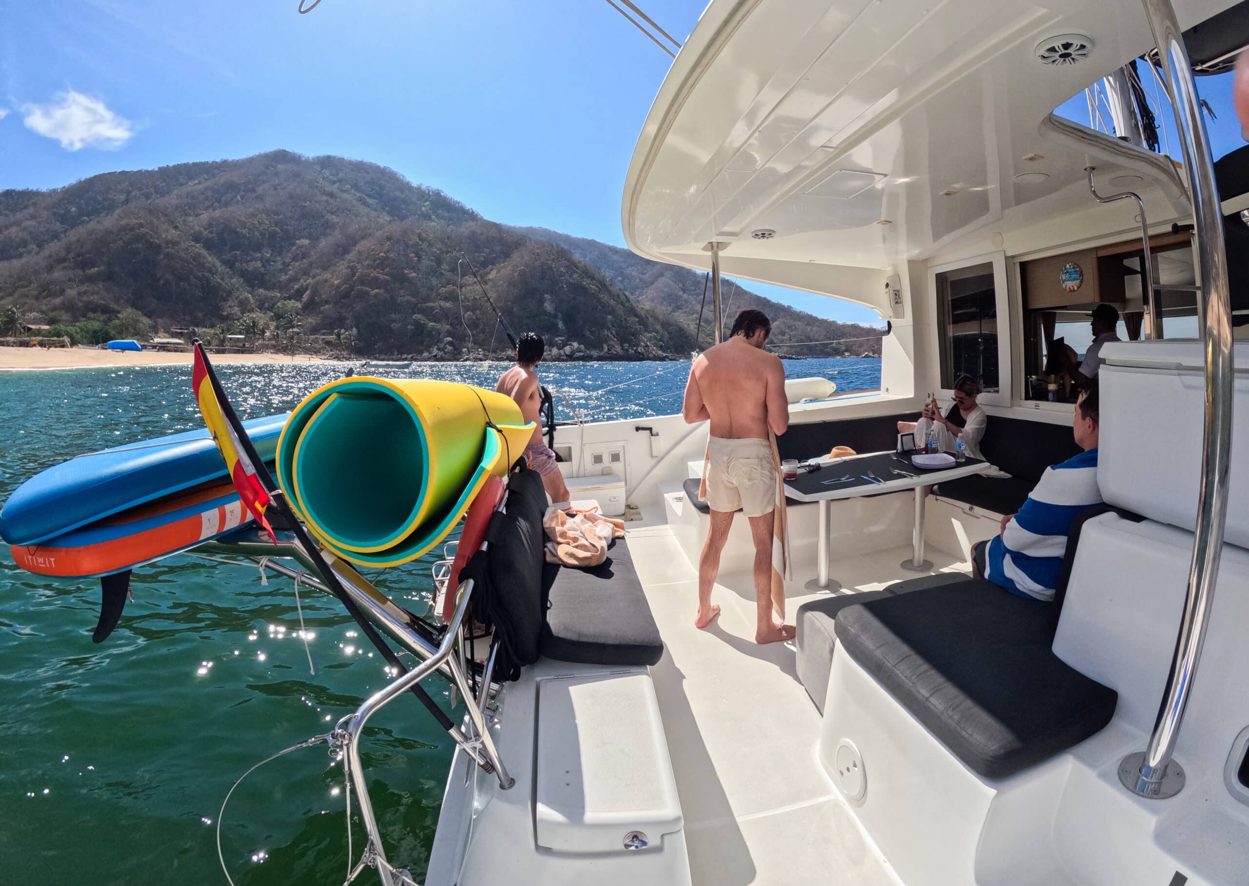 passengers ready to swim off catamaran